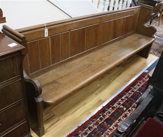 A church pew W.230cm